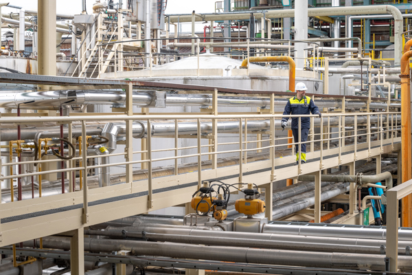 Employee walking in an installation at Oleon Oelegem